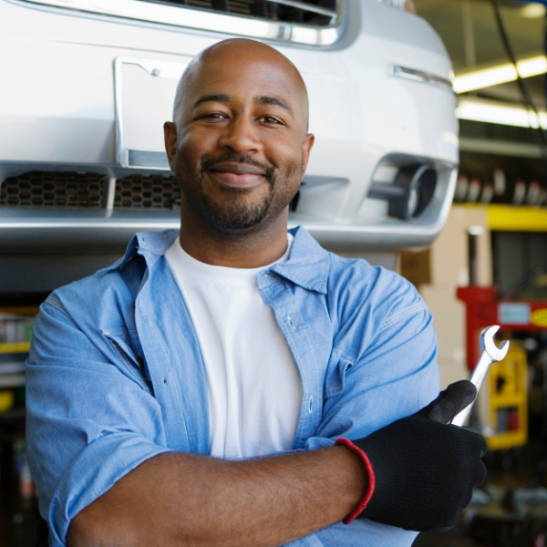 Car frames on an assembly line inside an automotive repair facility.