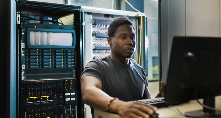 man working on database center computer