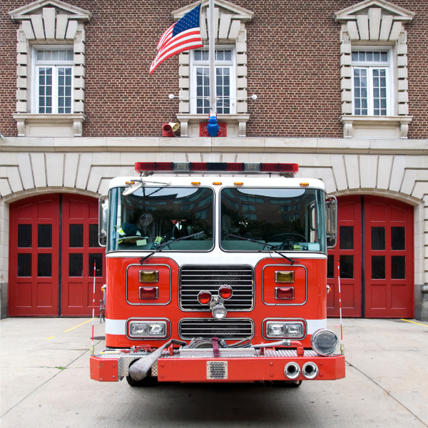 fire truck in front of a fire station