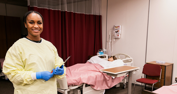 nursing assistant student with dummy practicing skills