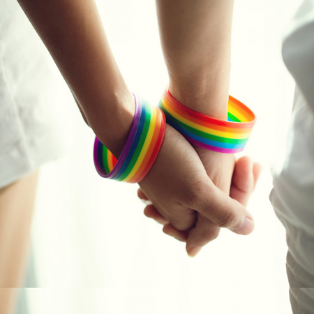 holding hands with rainbow bracelet