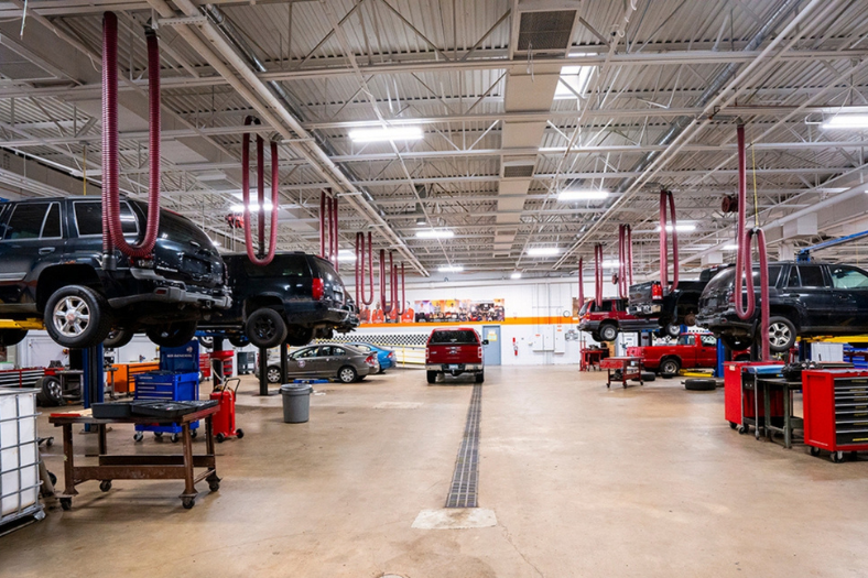 Vehicles on lifts in auto shop classroom lab