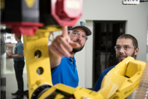 Instructor and student with robotic arm
