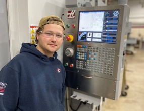 Hennepin Tech student Stephen Stolberg with machine