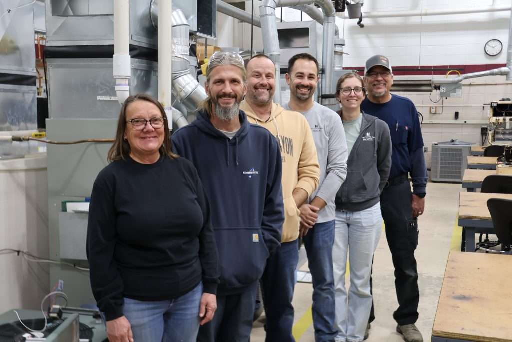 Eden Prairie HVAC/R faculty stand in a group in the HVAC lab.